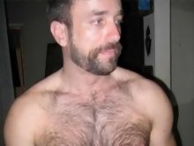 Topless dude showing off his hairy chest and flexing muscles